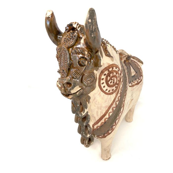 A vintage Pucára Folk Art bull sculpture from Peru, with hand-painted ornamentation in beige and brown tones, showcasing traditional bull design.