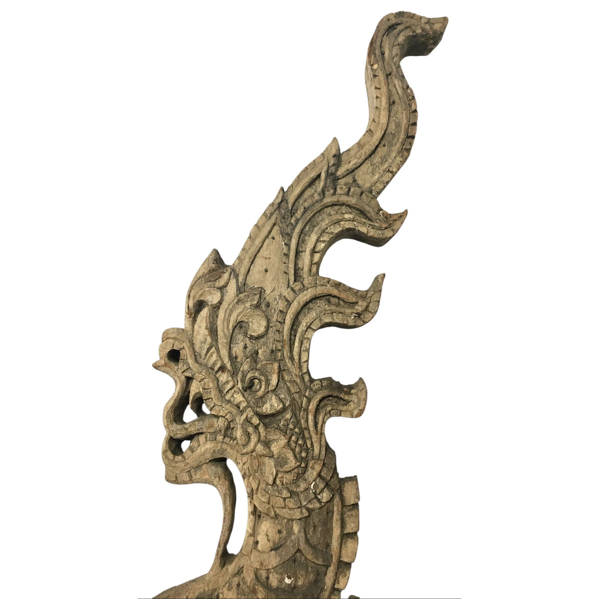 Head of an antique 1800s Thai wooden temple dragon architectural element with intricate carvings and a natural patina.