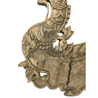 Body of an antique 1800s Thai wooden temple dragon architectural element with intricate carvings and a natural patina.