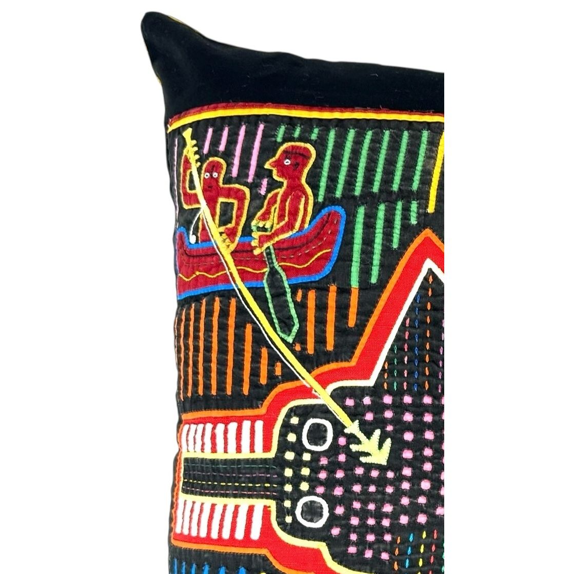 Colorful decorative pillow with geometric patterns on a black background