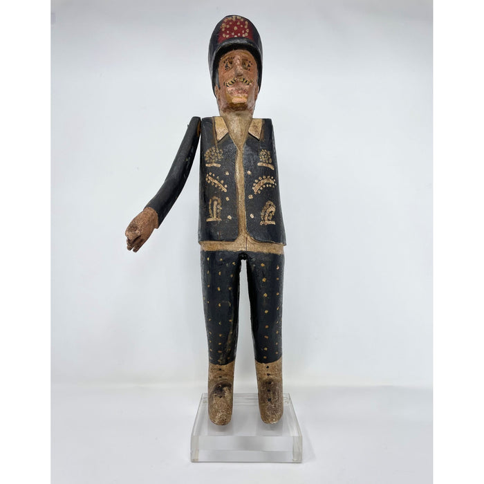 Hand-carved wooden sculpture of a Colonial Philippine police officer with a high peaked cap, decorative painted patterns on the uniform, and mounted on an acrylic base.
