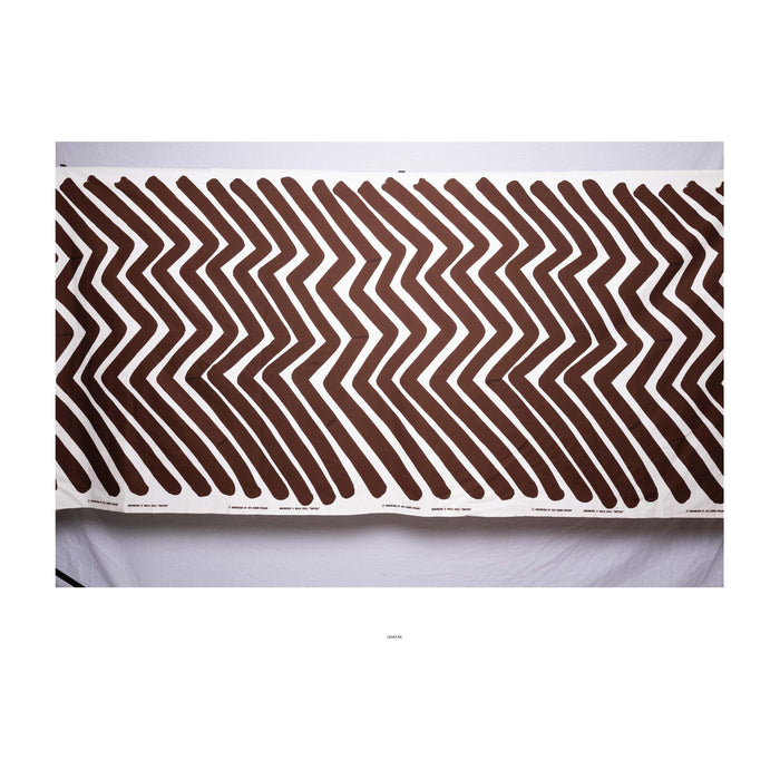 Vintage 1975 Marimekko fabric featuring a geometric pattern with dark chocolate brown stripes on a bright white background. MAIJA ISOLA TRAKTORI SUOMI FINLAND 1975. 