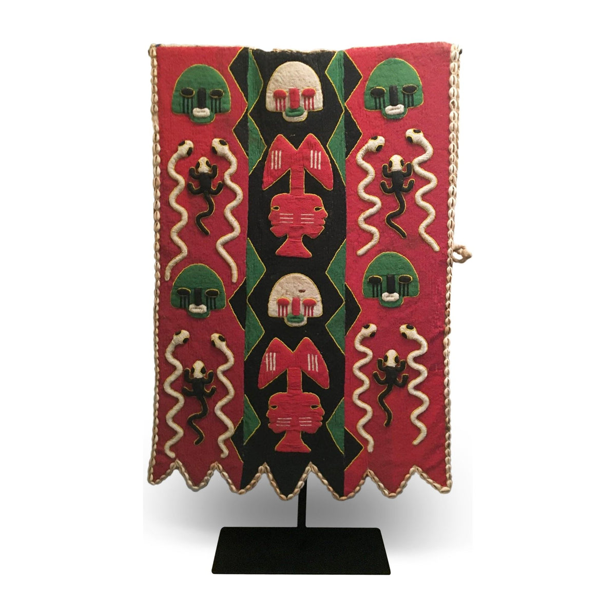 1950s Yoruba ceremonial beaded tunic with animal motifs and abstract patterns, displayed on a metal stand.